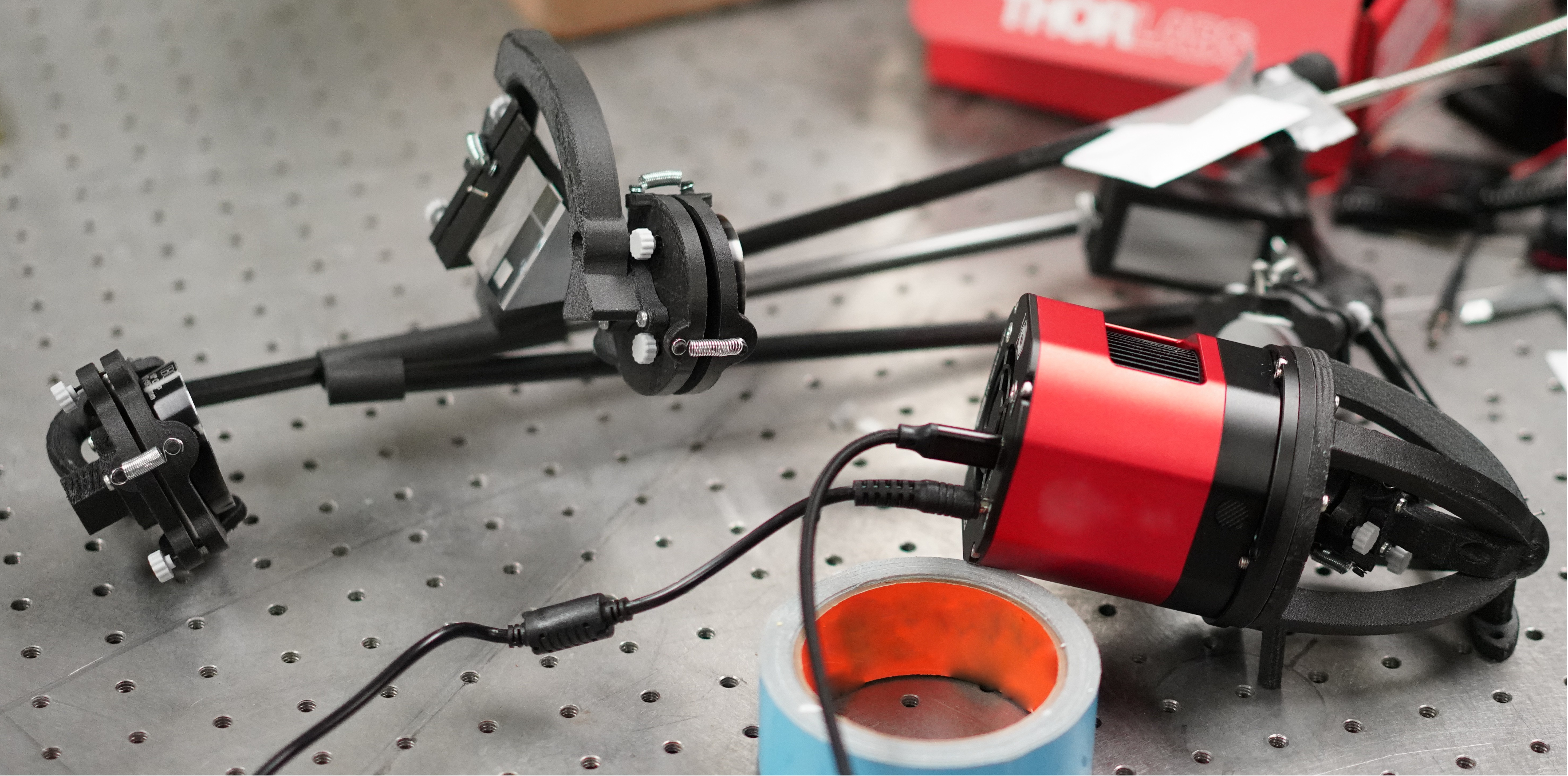 Opticco echelle spectrometer prototype with a carbon-fiber optical frame and cooled detector on an optical table